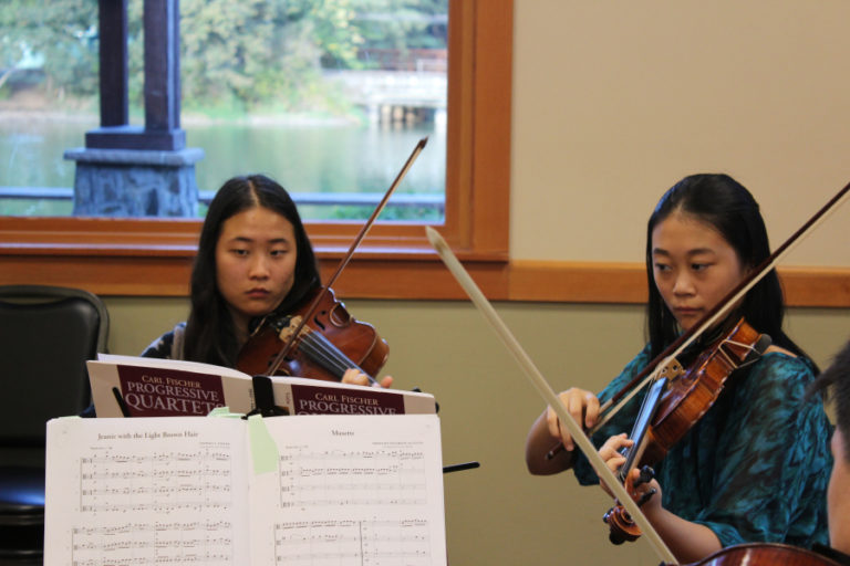 Camas High School seniors Xiansheng Yan (left) and Angela Xu (right) perform at the 2018 Camas State of the Community address, held Tuesday, Sept.