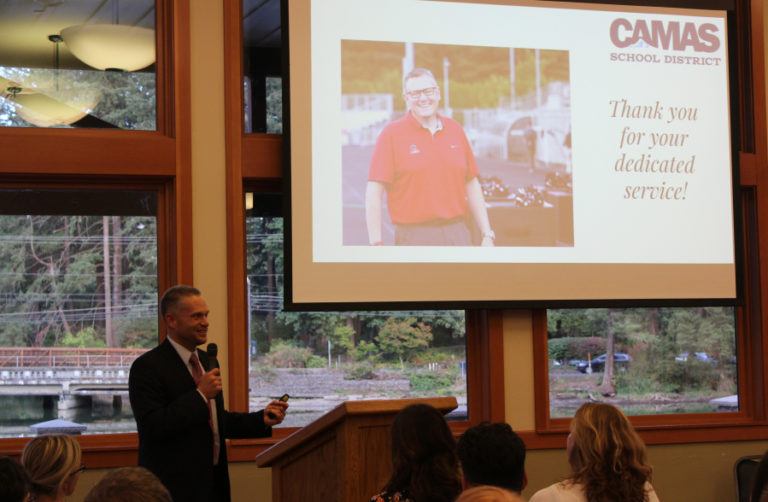 Camas School District Superintendent Jeff Snell (left) ends his 2018 State of the Community address Tuesday, Sept. 18, by introducing outgoing Camas Mayor Scott Higgins (on screen) and thanking him for his 16 years of public service.