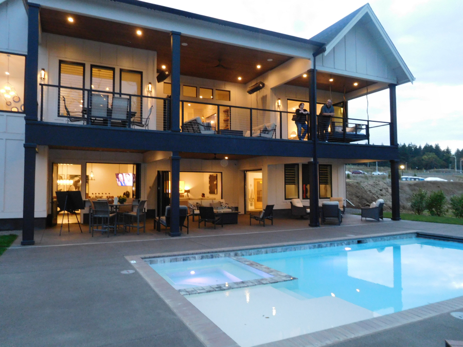 The outdoor living area at "The Madison," by Generation Homes Northwest, features an in-ground pool and hot tub. It was one of 10 Camas homes featured in the 2018 NW Natural Parade of Homes.