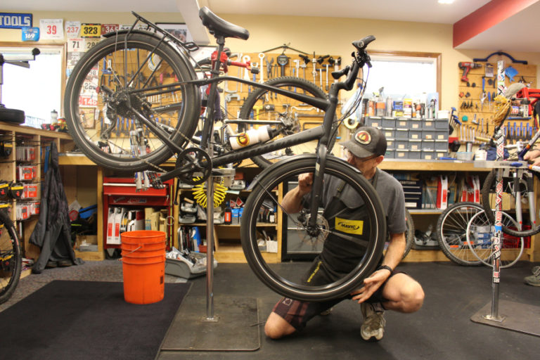 Camas Bike and Sport employee Bill Waring services a bicycle in the shop, Sept. 21. Owner Ed Fischer said he was worried about cutting hours for employees during event weekends downtown.