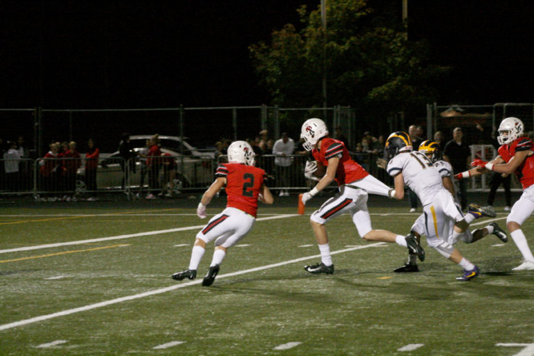Camas&#039; Luc Sturbelle pulls away from Bellevue defenders at a close game Sept. 21.
