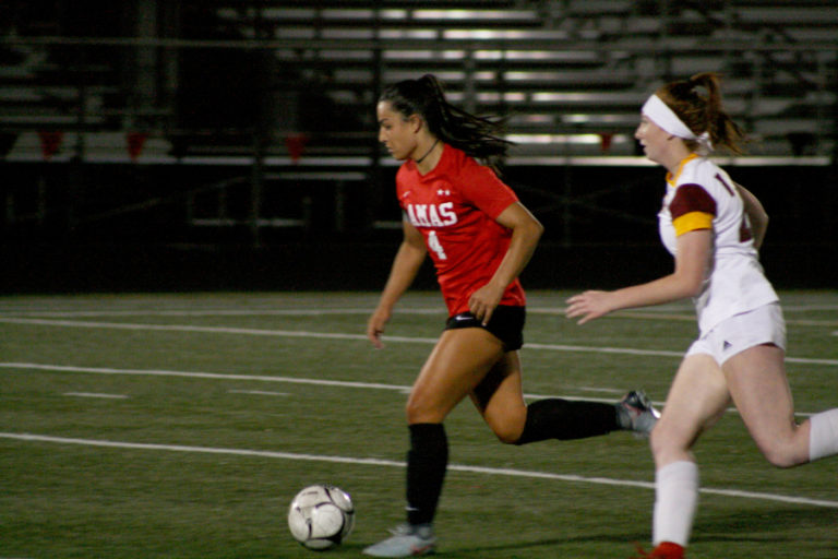 Papermaker forward Maddie Kemp (left) weaves her way through defenders on her way to her sixth goal of the game, Sept.