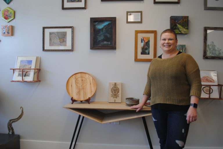 Lori Lander, co-owner of Artful Attic, poses with some of her work at the shop on Oct. 4.
