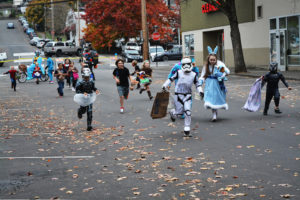 Trick-or-treaters run through the streets of downtown Camas in search of treats during the 2017 Boo Bash. (Post-Record file photo)