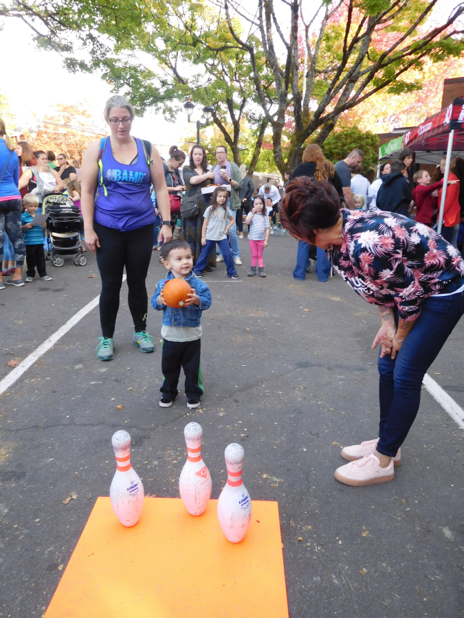 Children enjoy games of pumpkin bowling during the Harvest Festival, Oct. 3, at the Camas Farmer&#039;s Market. The festival also includes a cookbook and gardening magazine exchange and live music. The Camas Farmer&#039;s Market will resume Wednesday, June 5, 2019.