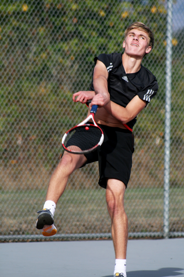 Camas High senior Rylan Marshall powers an overhead smash against Union High&#039;s No. 1 doubles team, Oct. 3. Marshall and his partner, Jacob Gianan, won their match in three sets.