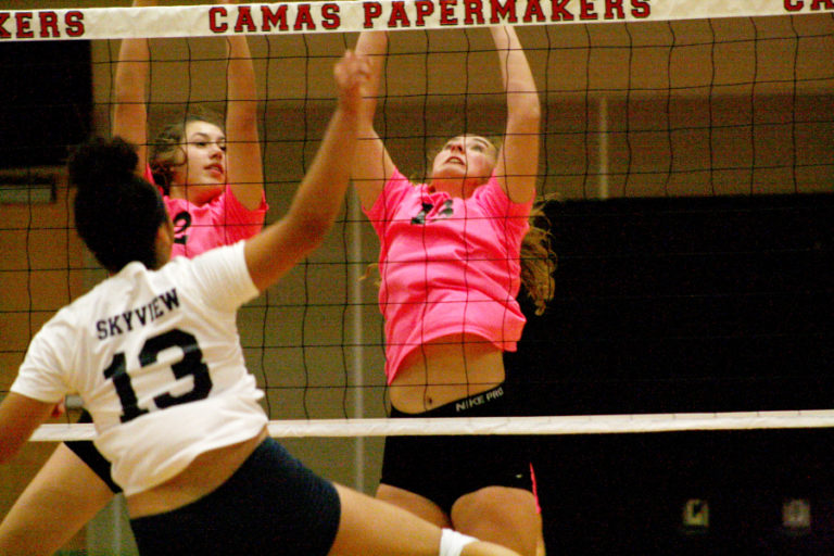 Camas sophomores Kate Golb (left) and Mackenzie Hancock (right) cover the net during a five-game match against Skyview on Oct. 2.