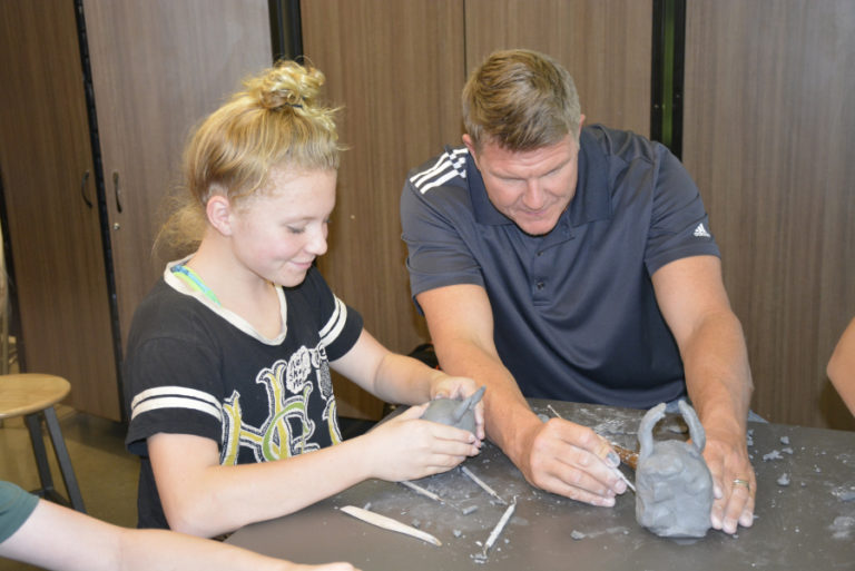 Landey Albaugh (left) and her father, Adam Albaugh (right), work on clay projects for Landey&#039;s art class at Jemtegaard Middle School on Oct. 11. Adam accompanied his daughter to school for the annual &#039;Take Your Parents to School&quot; event.