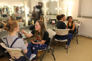 Washougal High School drama students (left to right) Emma Free, Aubrey Turner, Deni Modisette and Alexis Brock experiment with horror makeup Oct. 20, while taking direction from Washougal High senior Tori Corkum (in mirror reflection), the organizer of this year's student-run "Screen Screams" haunted house.