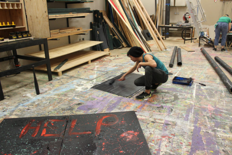 Washougal High School (WHS) junior Shane Fussell, 16, paints props Oct.