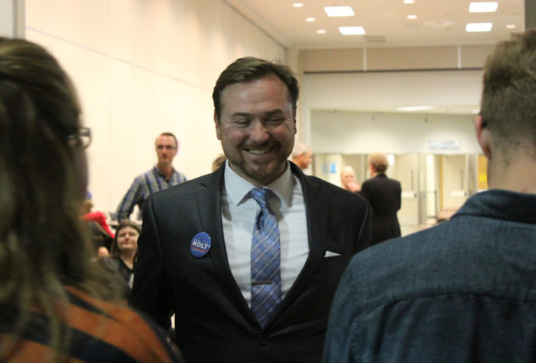 Democratic candidate Eric Holt, running for Clark County Council Chair (center), laughs with community members Oct.