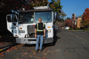 Garry Reed, Camas sanitation lead, stands in front of his garbage truck on Oct. 22. Reed has been picking up trash in Camas for 25 years. 