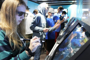 Discovery High freshman Chloe Bell, 14, dissects a spider on an "all-in-one" zSpace computer inside the zSpace virtual reality bus Oct. 17. 