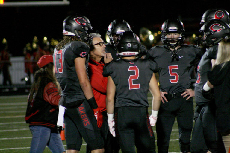 Camas football coach Jon Eagle talks to his team after their starting quarterback left the game on crutches, Oct. 19.  Blake Ascuitto (5) stepped in, and helped bring Camas a 48-35 victory.