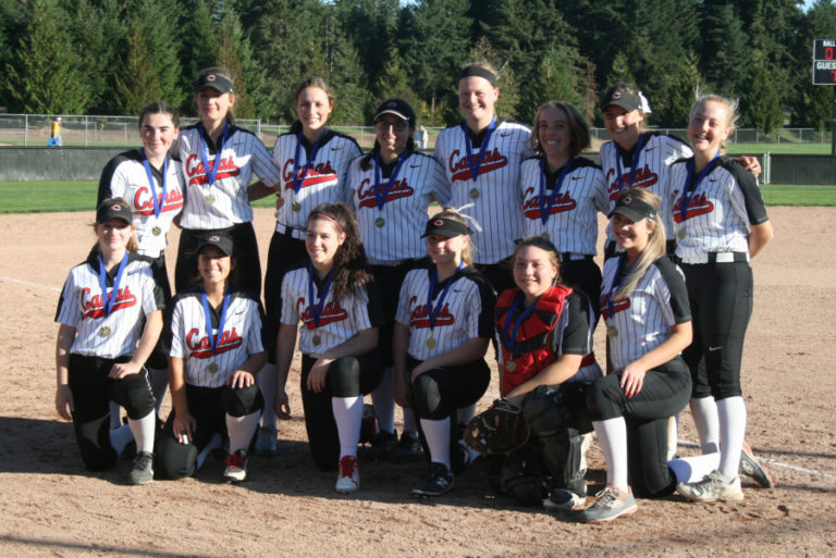 The Camas Papermakers slowpitch softball team smiles for the camera after winning districts on their home field, Oct.
