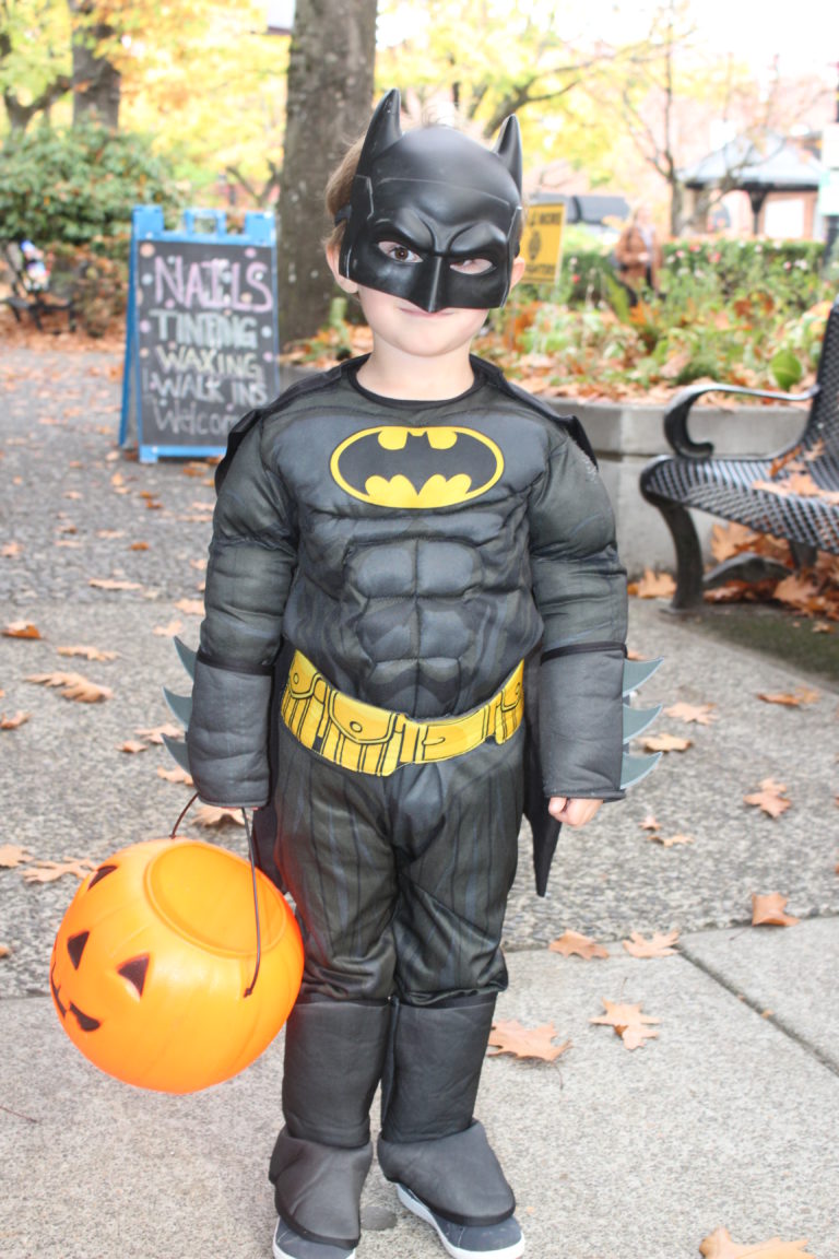 Caped crusader Barrett Vaughn, 4, of Camas, carries his pumpkin candy bucket during the 2018 Boo Bash in downtown Camas, on Wednesday, Oct. 24.