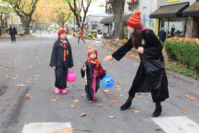 A Hogwarts family makes their way down Northeast Fourth Avenue in Camas during the 2018 Boo Bash, on Wednesday, Oct. 24. Pictured: Mom Kelly (right) with her two children, Julamani, 6 (left), and Jameson, 3 (center).  