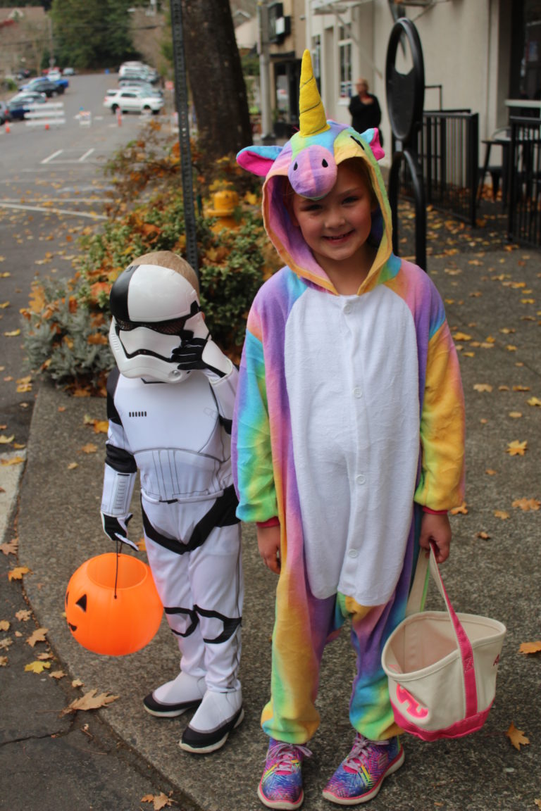 Unicorn Addison Hausmann, 7, and her 3-year-old brother, Jake Hausmann, of Camas, wait at the corner of Northeast Fourth Avenue and Northeast Cedar Street during the 2018 Boo Bash, Oct. 24. 