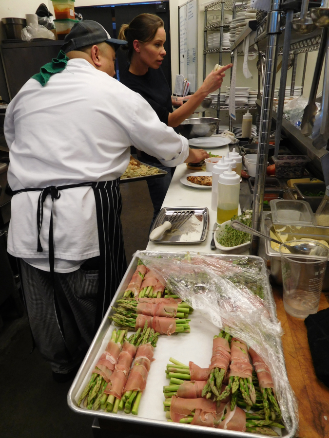 2 Rivers Bar &amp; Grill Executive Chef Duane Jose (left) and Sous Chef Leslie Champion (right) prepare prosciutto-wrapped asparagus, grilled cajun chicken breast and a cheeseburger during the 2 Rivers Bar &amp; Grill &quot;soft opening&quot; on Oct. 25. The new restaurant is located at 1700 Main St., Washougal.