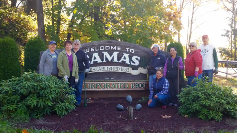 Members of the Camas-Washougal Garden Club stand near the &quot;Welcome to Camas&quot; city entrance sign off Highway 14 on Oct. 27.