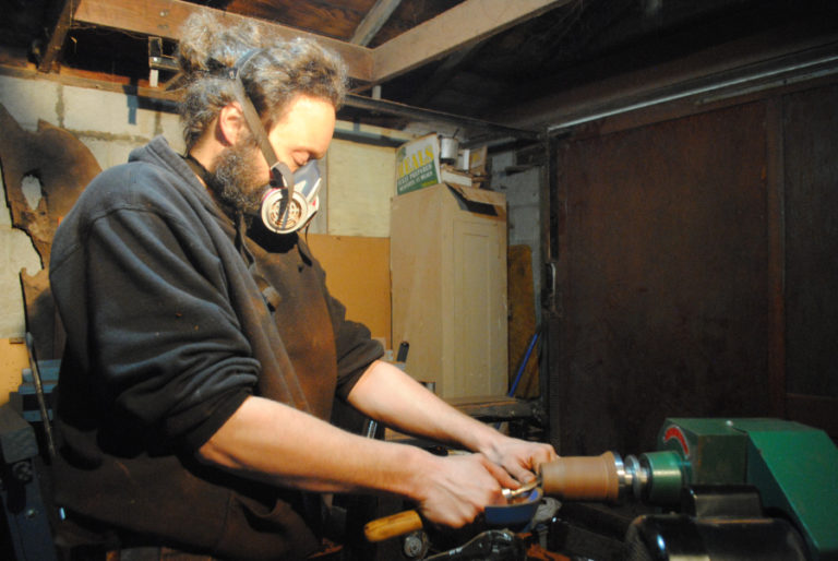 John Furniss adjusts his lathe in his workshop on Nov. 3.