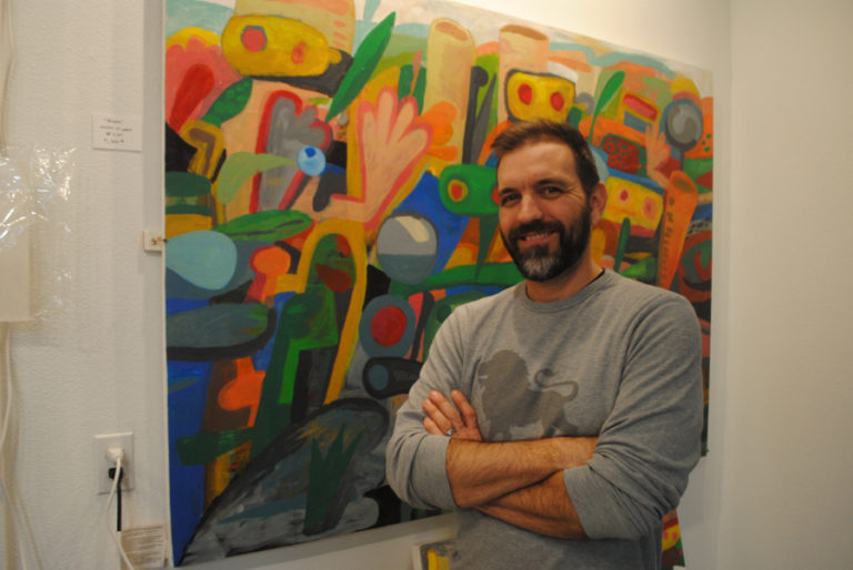 Paul Solevad poses with one of his pieces in his studio on Nov. 3.