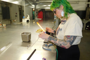 Stephanie Carmichael, of Portland, makes a pendant at the Washougal-based Mary Jane's Glass Productions. Carmichael sells her glass products, which also include caps for dabbing cannabis oil concentrates, on etsy.com.