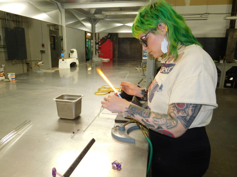 Stephanie Carmichael, of Portland, makes a pendant at the Washougal-based Mary Jane&#039;s Glass Productions.