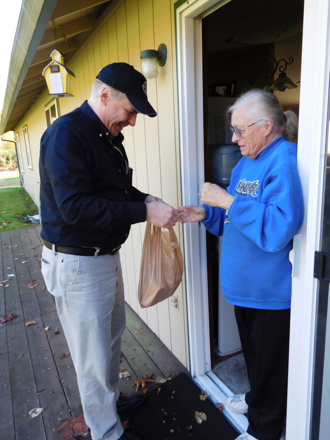 Kris Isaacson, a new Meals on Wheels floor manager, delivers chicken stroganoff to Hannah Mae Crum at her house in Washougal, on Nov. 8. The Meals on Wheels People delivers meals to homebound seniors 60 and older, and they provide lunches at several area locations including the Washougal Community Center. (Dawn Feldhaus/Post-Record)