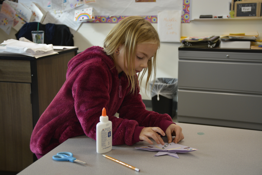 Allison Sipe, a second-grader at Columbia River Gorge Elementary School in Washougal, makes origami ornaments. (Contributed photos by Rene Carroll courtesy of Washougal School District)