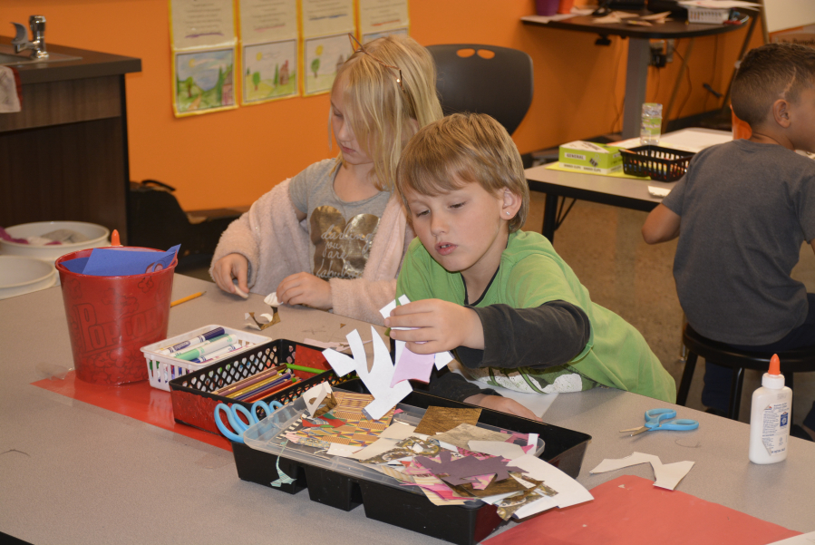 Gwenyth Kench (left) and Christian Abbott (right) make holiday ornaments at Columbia River Gorge Elementary in Washougal.