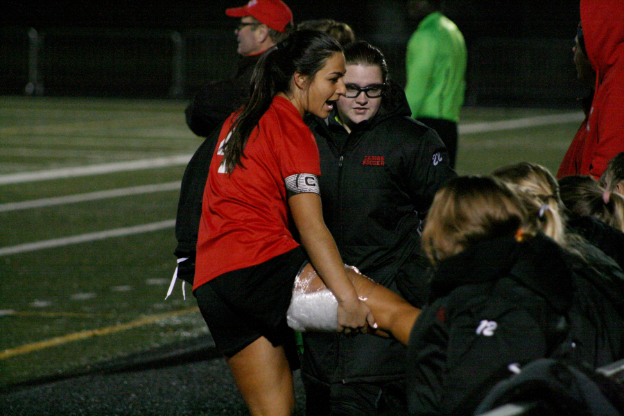 Maddie Kemp leaves the state playoff game against Jackson early and gets some ice from the trainer after reinjuring her hamstring.  Kemp scored the only goal of the game. (Wayne Havrelly/Post-Record)