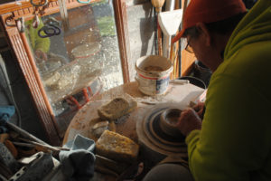 Ted Norris works at the pottery wheel in his garage studio on Nov. 15. Norris has been a potter for 45 years.
