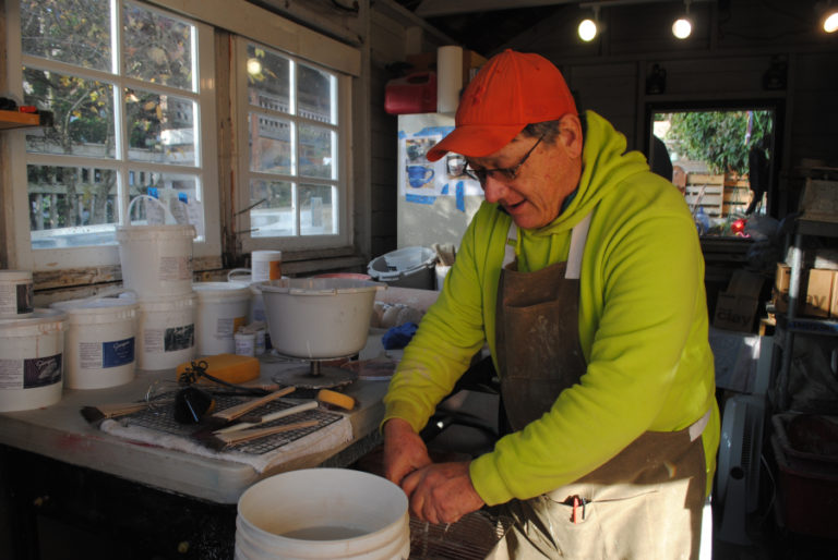 Ted Norris glazes a pot in his studio on Nov. 15.