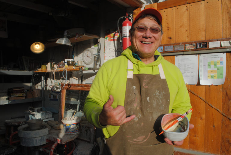 Ted Norris poses with a ramen bowl he made outside his studio on Nov. 15.