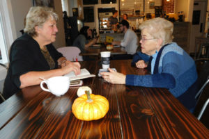 Washougal Mayor Molly Coston (left) listens to former Camas Mayor Nan Henriksen (right), at Hidden River Roasters in downtown Camas. Henriksen has provided encouragement and perspective for Coston on a weekly basis since January 2018. 