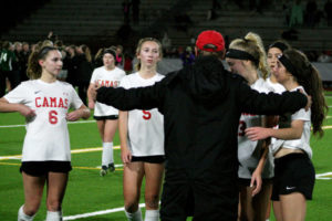 Camas soccer coach Roland Minder comforts his team as the horn sounds at the state finals in Puyallup, Wash., Nov. 17, ending the Papermakers' season and the career of the most successful soccer coach in Camas history.