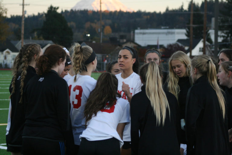 The Papermakers concentrate on their game plan with Mount Rainier in the background at Sparks Stadium in Puyallup, Wash.
