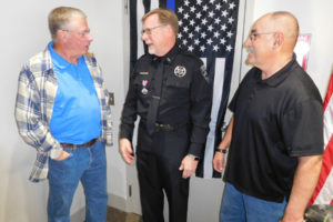 Retired Washougal Police Chief Bob Garwood (left) and retired Washougal Police Sgt. Brad Chicks (right) congratulate the department's newest retiree, Officer Jon Cotton (center), during a reception, Nov. 20. Cotton, 59, served as a Washougal Police reserve officer for seven years and a patrolman for 28 years. 