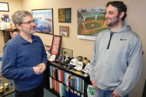 Washougal City Manager David Scott (left) and Washougal Accounting Specialist Lee Bowles (right) talk in Scott's office in City Hall. Scott and Bowles are participating in "No-Shave November," a monthlong effort to put away the razor, increase awareness about cancer and donate to cancer prevention, research and education. 