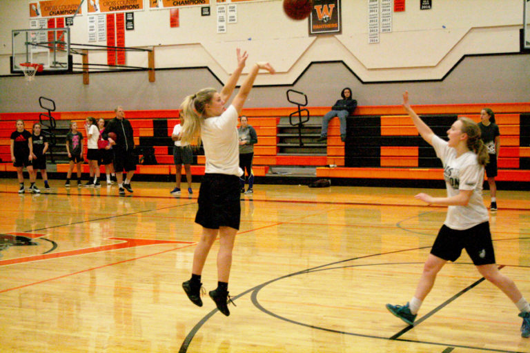 Senior Ashley Gibbons works on her shooting form as she drills a three point shot during one of the first practices of the season in the Washougal High School Gym.