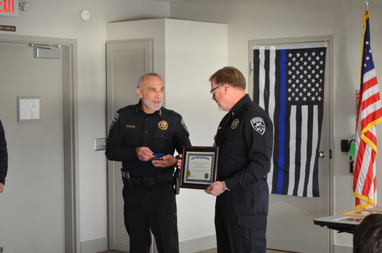 (Contributed photo courtesy of Kate Tierney)
Washougal Police Chief Ron Mitchell (left) presents Officer Jon Cotton (right) with a lifesaving award during a Nov. 20 ceremony, at Cotton’s retirement reception. Mitchell commended Cotton for saving the life of a suicidal woman who had jumped into the frigid Columbia River in October 2016.