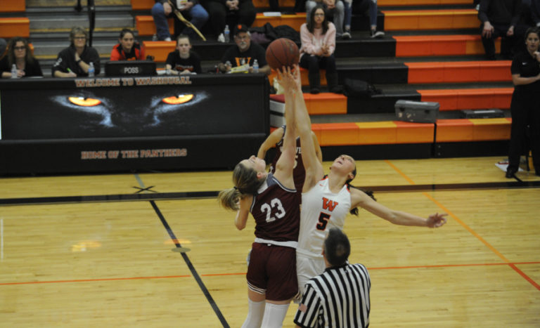 The tipoff between Beyonce Bea, of Washougal, and W.F. West&#039;s Erika Brumfield. Brumfield seriously injured her knee and had to leave the game, Nov.