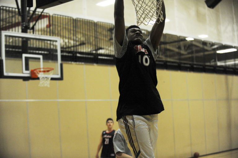 Camas High 6&#039;6&quot; senior guard, Isaiah Sampson, throws down a dunk during a drill in practice.