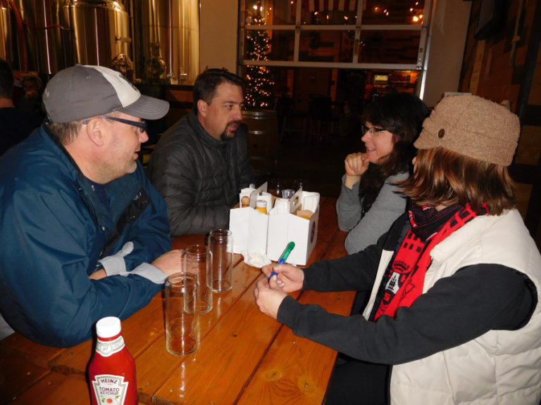 Matthew McBride (front left) and his wife, Laura (front right)), and their friends Kevin and Danielle Tyler (background), form the team, the &quot;Noel-It-Alls,&quot; for the Dec. 5 trivia night competition at 54?40&#039; Brewing Company, in Washougal.
