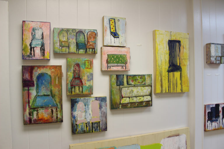 Several of artist Heidi Jo Curley&#039;s &quot;chair series&quot; paintings adorn the walls of her new art studio in downtown Camas.