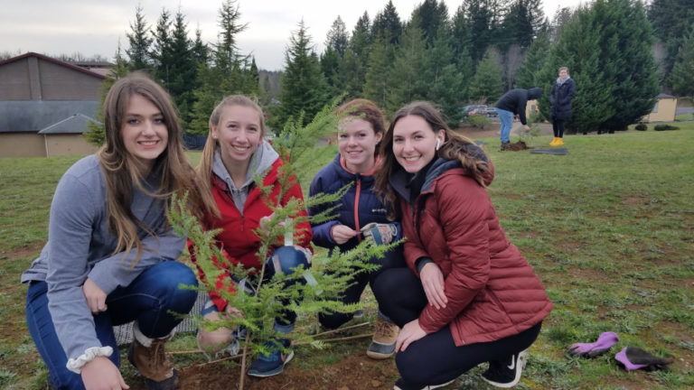 From left to right: Camas High School students Mary Pipkin, Sierra Scordino, Elaina DeMerritt and Carla Jooste help plant native saplings on Dec.