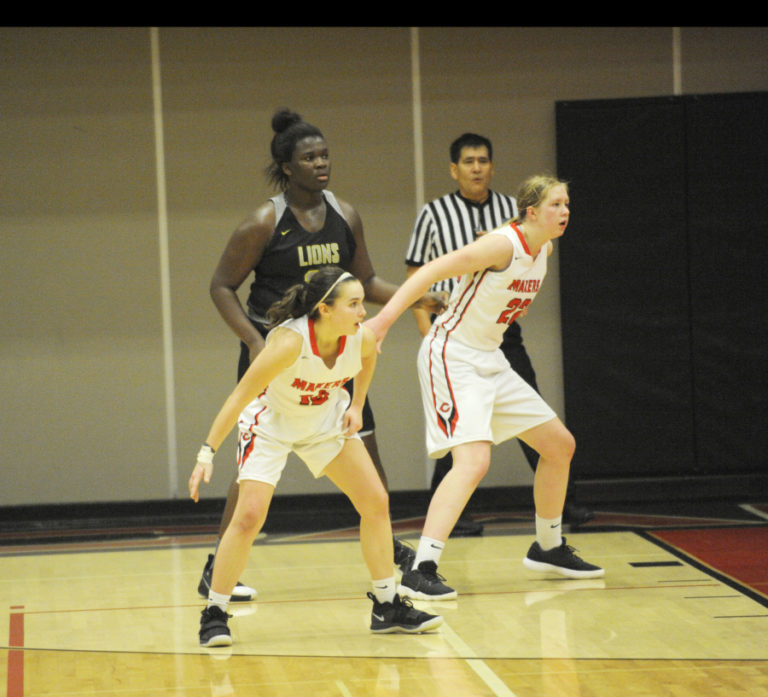 Papermakers Hannah Booth and Faith Bergstrom help each other on defense by fronting 6-4 Aaronette Vonleh from West Linn.