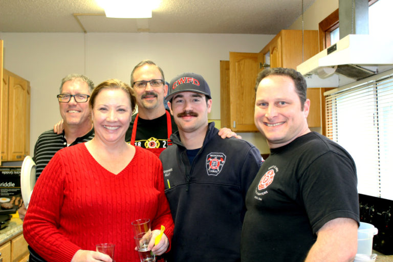 Camas Mayor Shannon Turk (second from left) helps members of the East Clark Professional Fire Fighters union clean after a free community breakfast on Christmas Eve. Pictured with Turk, from left to right, are firefighter-paramedic Shayne Bradley, firefighter-paramedic Capt.
