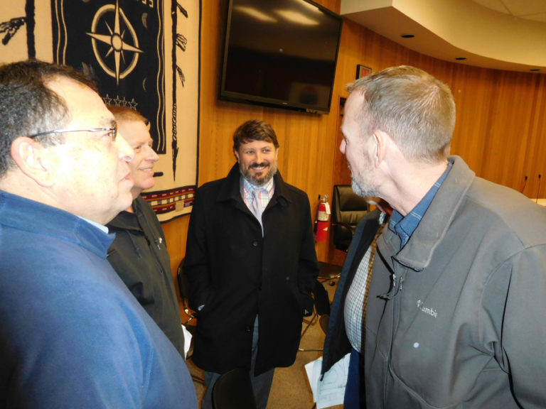 Jamie Howsley (center), the land use attorney for NorthSide 4, LLC, meets with clients after a Dec. 20 public hearing about the proposed Northside residential development in Washougal.